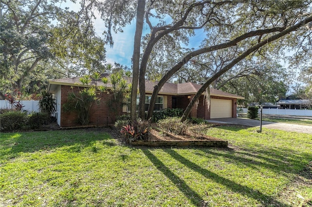 single story home with a front yard and a garage