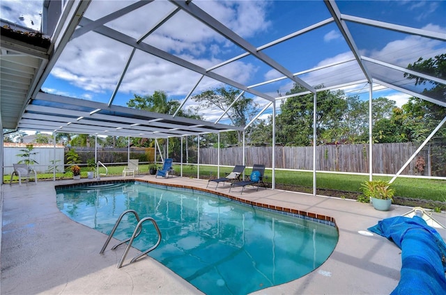 view of swimming pool with glass enclosure and a patio