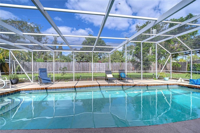 view of swimming pool featuring a patio area and a lanai