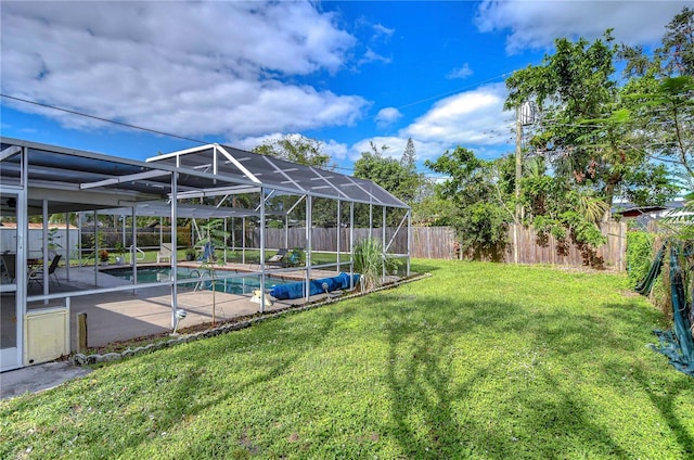 view of yard with a fenced in pool, a patio area, and a lanai