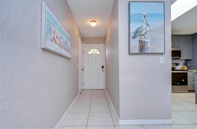 doorway to outside with light tile patterned flooring