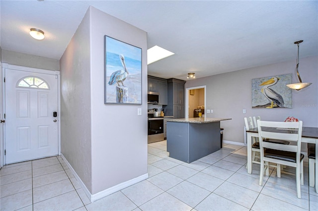 foyer entrance with light tile patterned floors