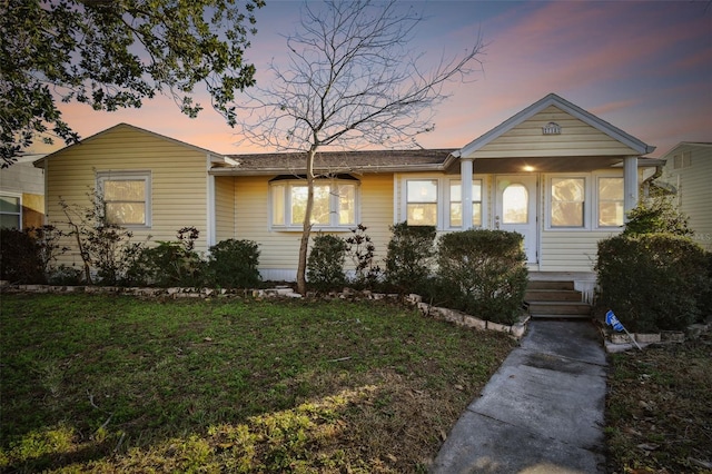 ranch-style home with a lawn