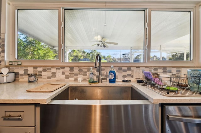 kitchen with backsplash, ceiling fan, sink, and a healthy amount of sunlight