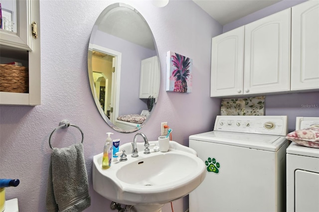 bathroom featuring sink and independent washer and dryer