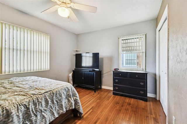 bedroom with hardwood / wood-style floors, a closet, and ceiling fan