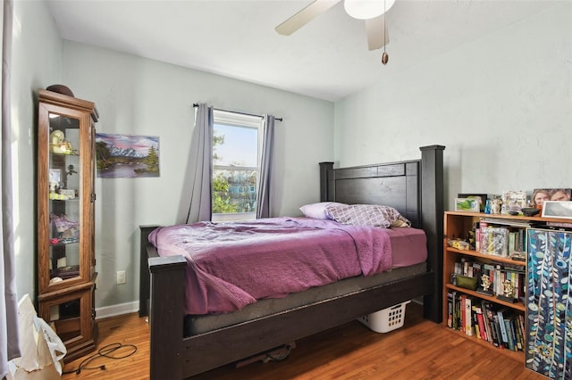 bedroom with ceiling fan and hardwood / wood-style flooring