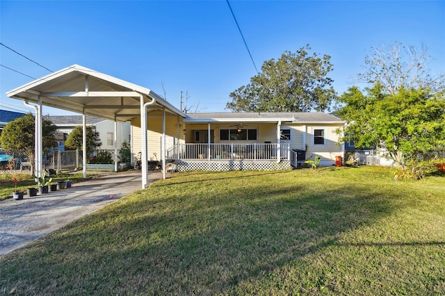 rear view of property featuring central air condition unit, a yard, a porch, and a carport