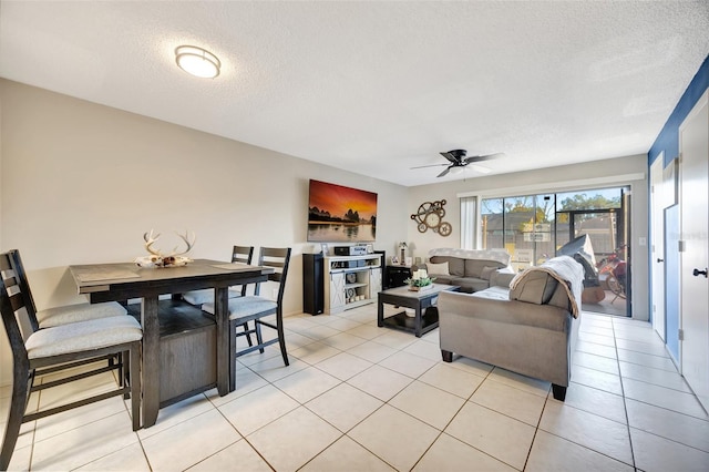 tiled living room featuring ceiling fan and a textured ceiling