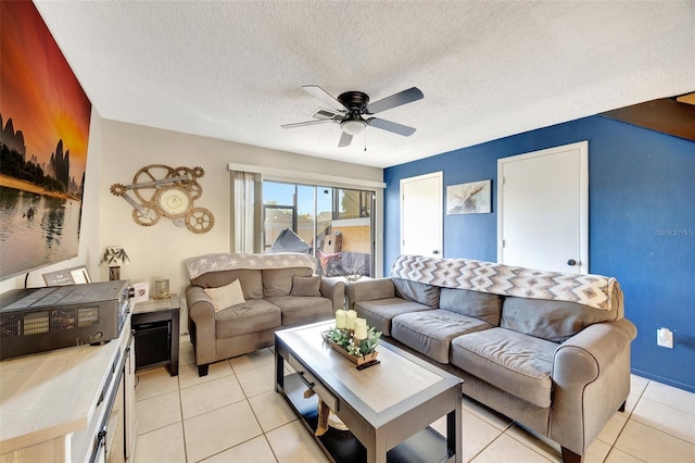 tiled living room with ceiling fan and a textured ceiling