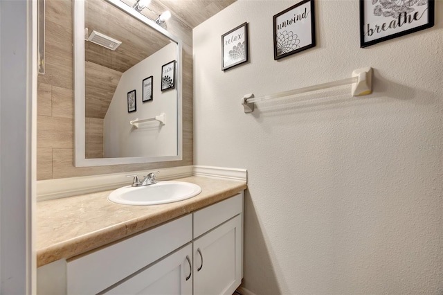 bathroom featuring vanity, lofted ceiling, and wood ceiling