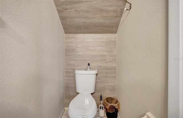 bathroom featuring toilet and lofted ceiling