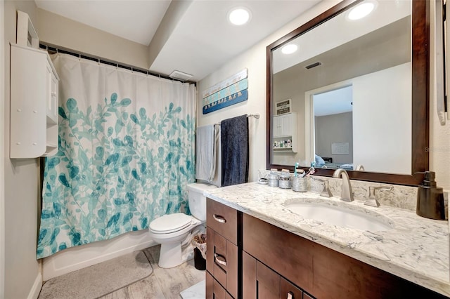 full bathroom featuring vanity, toilet, and shower / bathtub combination with curtain