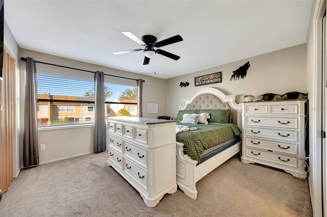 bedroom featuring ceiling fan and light carpet