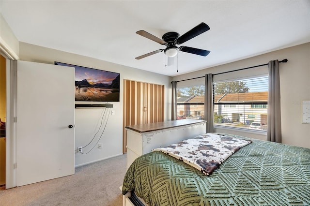 bedroom with light colored carpet and ceiling fan