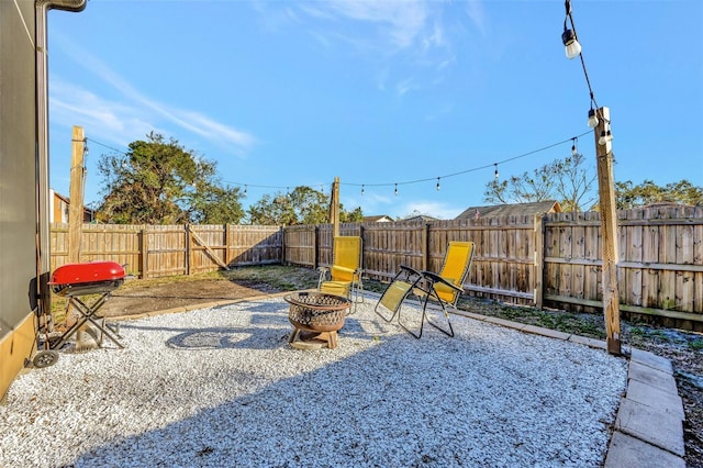 view of yard featuring a patio area and a fire pit