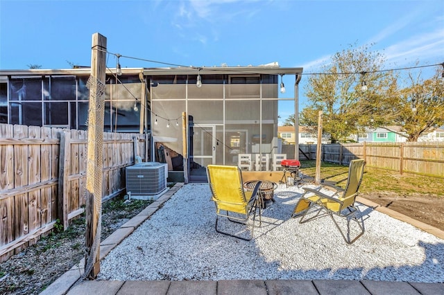 view of patio / terrace featuring central AC and a sunroom