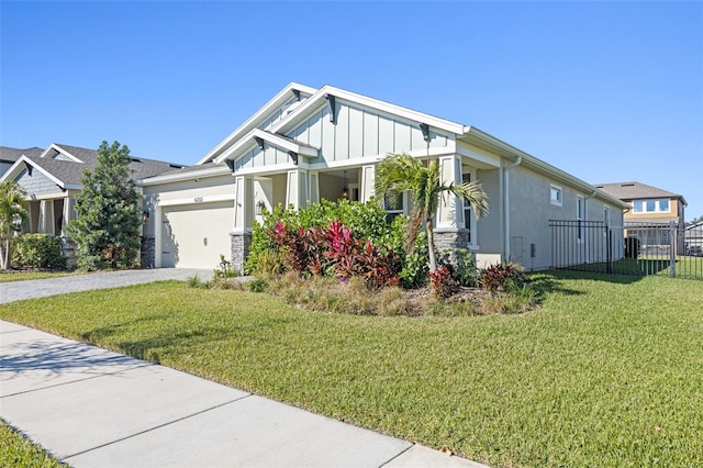 craftsman house with a front lawn and a garage