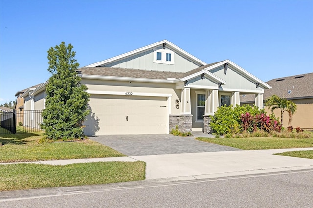 craftsman-style home with a garage and a front yard