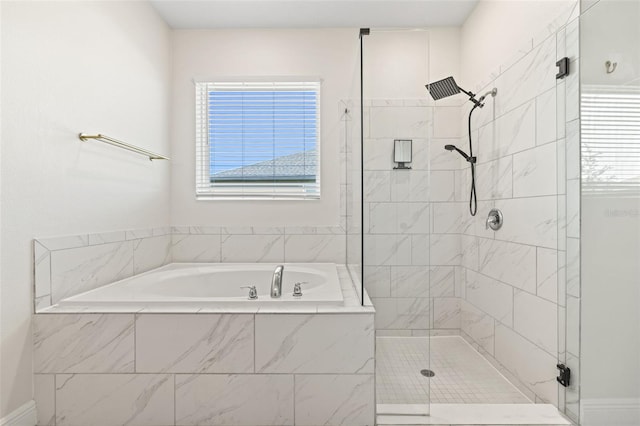 bathroom featuring shower with separate bathtub and a wealth of natural light