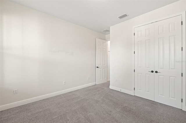 unfurnished bedroom with carpet and a closet