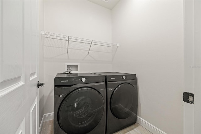 washroom featuring washer and dryer and light wood-type flooring