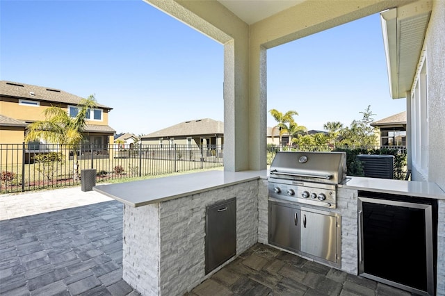 view of patio / terrace with an outdoor kitchen and a grill