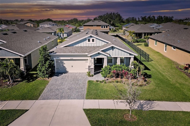 view of front of home featuring a yard and a garage