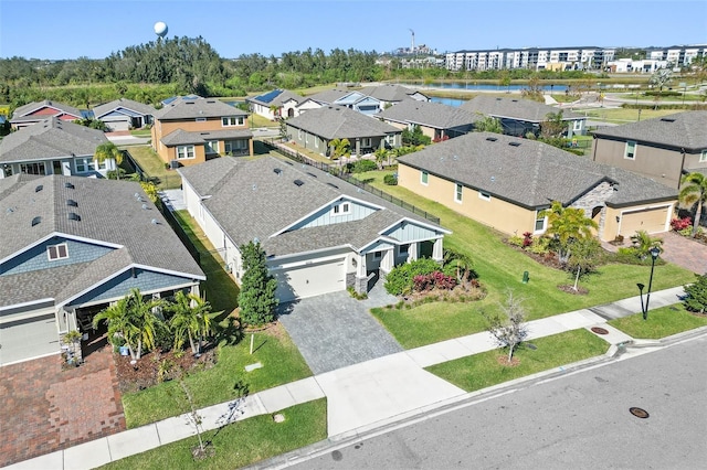 birds eye view of property with a water view and a residential view