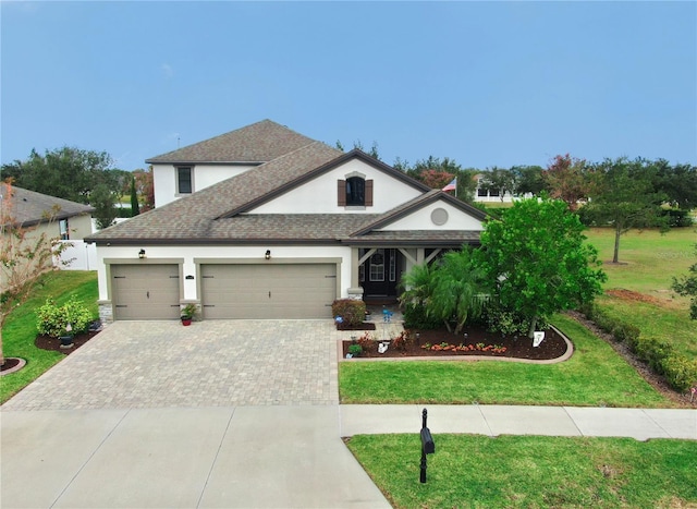 view of front of home featuring a front lawn and a garage