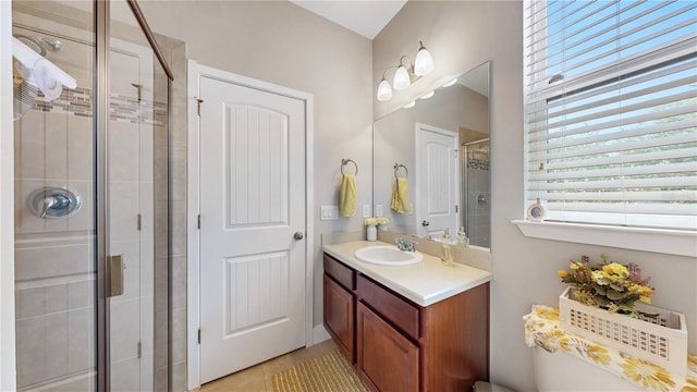 bathroom featuring a shower with door, tile patterned flooring, and vanity