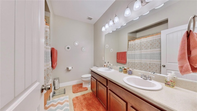 bathroom featuring curtained shower, tile patterned flooring, vanity, and toilet