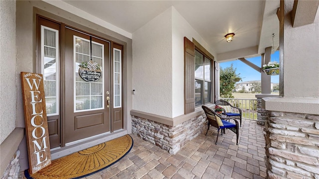 entrance to property featuring covered porch