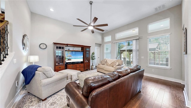 living room with ceiling fan and dark hardwood / wood-style floors