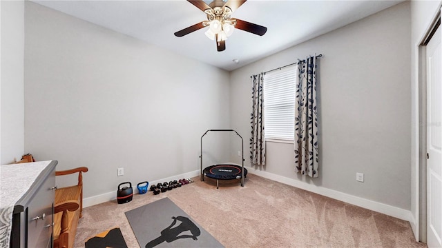 exercise room with carpet flooring and ceiling fan