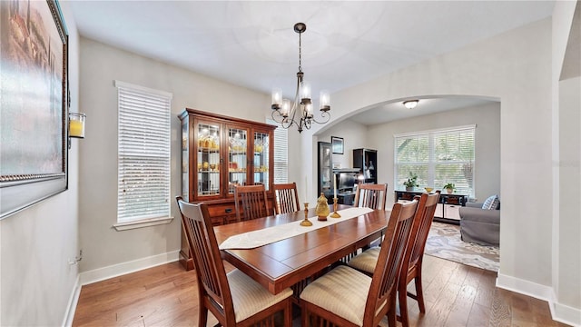 dining room with an inviting chandelier and hardwood / wood-style flooring