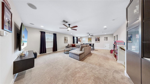 carpeted living room featuring ceiling fan