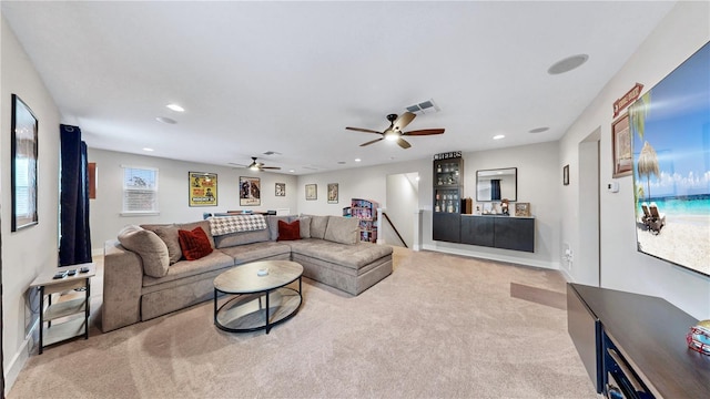 carpeted living room featuring ceiling fan