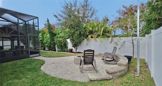 view of patio with a lanai and a fire pit