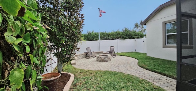 view of yard featuring a fire pit and a patio area