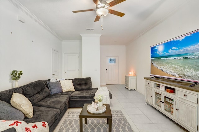 tiled living room with ceiling fan and ornamental molding