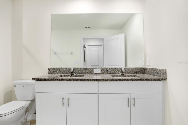 bathroom with vanity and toilet