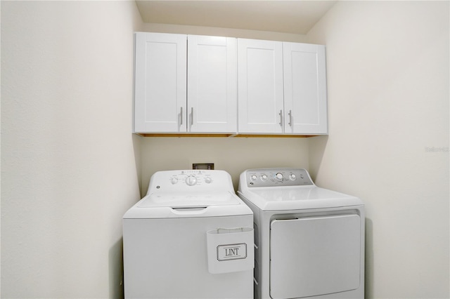 laundry area with cabinets and separate washer and dryer