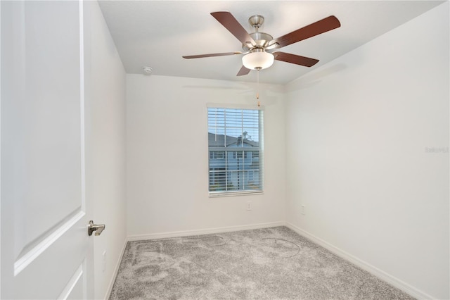 spare room featuring ceiling fan and light carpet