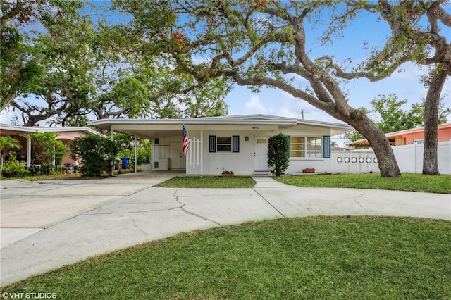 ranch-style home with a carport and a front yard