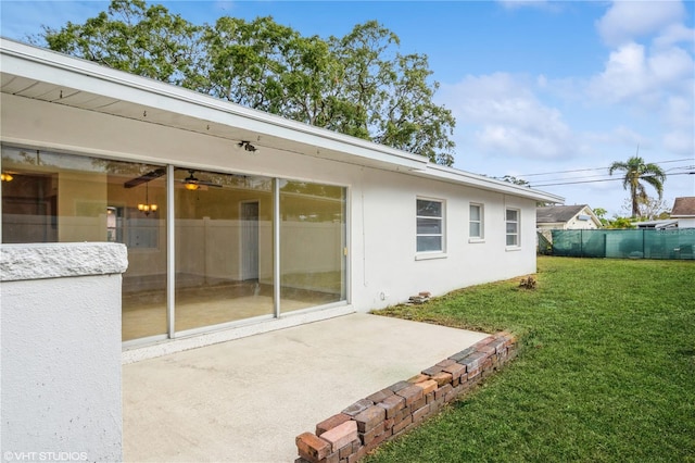 back of house featuring a lawn and a patio