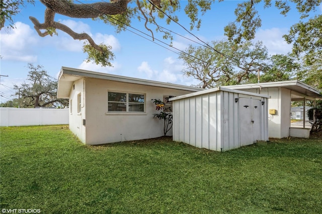 back of property featuring a yard