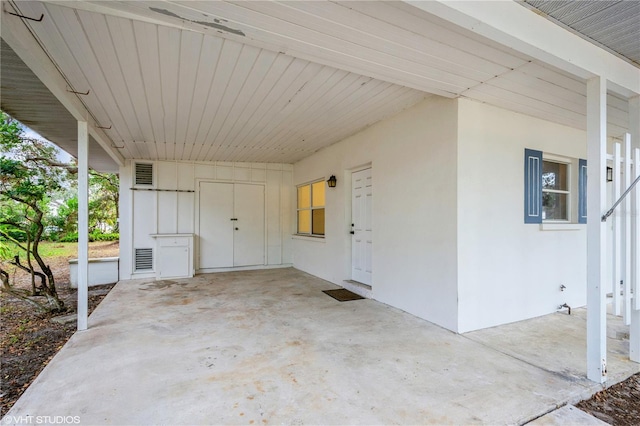 view of exterior entry featuring a patio area