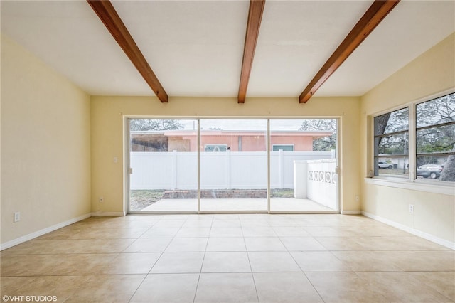 tiled spare room with beamed ceiling