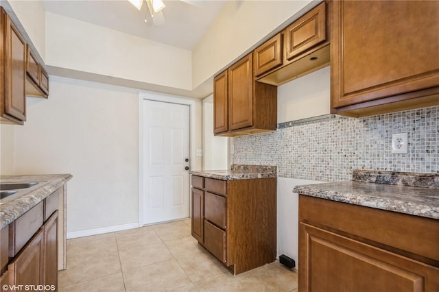 kitchen featuring backsplash, ceiling fan, and light tile patterned flooring